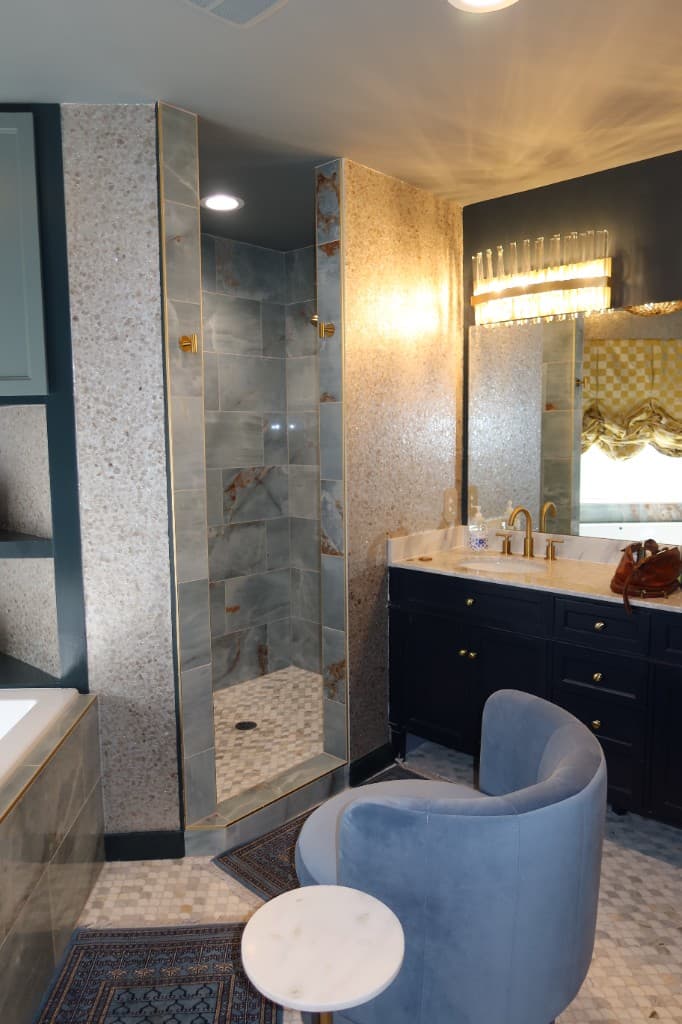 Luxury bathroom with marble tile walk-in shower and gold fixtures